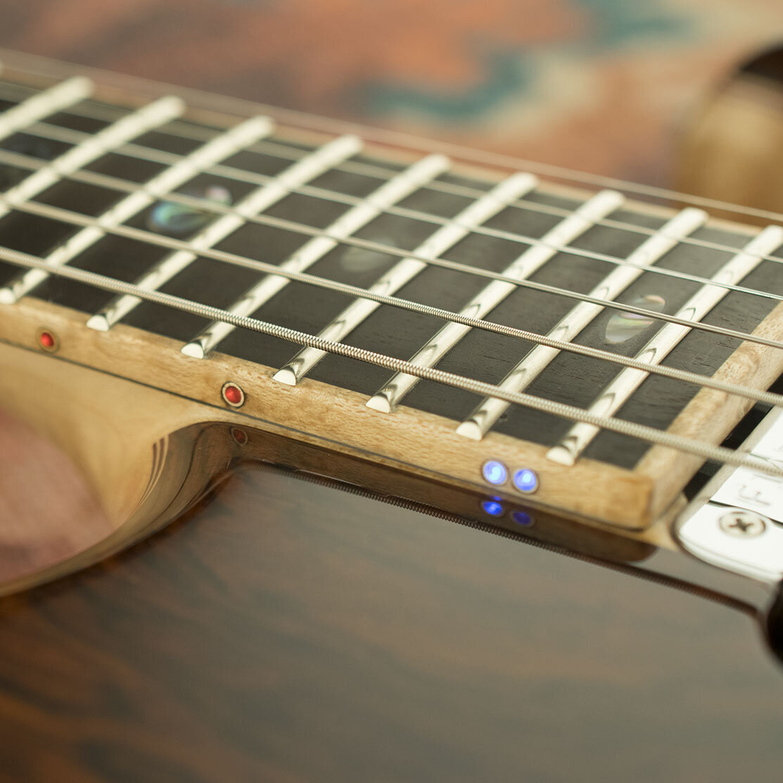 Bird's-eye Maple binding on Ebony fingerboard